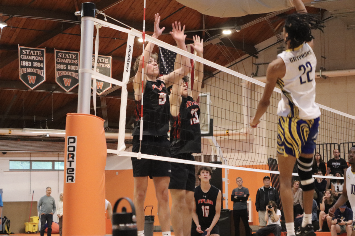 Junior captain Finn Bell and junior Max Walsh jump up to try and block the ball. Bell and Walsh had a combined 25 kills.